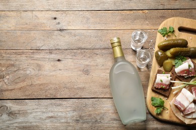 Photo of Flat lay composition with cold Russian vodka on wooden table. Space for text