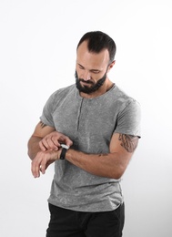 Portrait of handsome tattooed man on white background