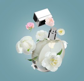 Bottle of perfume and peonies in air on dusty light blue background. Flower fragrance