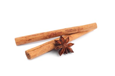 Photo of Aromatic cinnamon sticks and anise star isolated on white