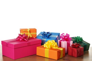 Photo of Colorful gift boxes on wooden table against white background