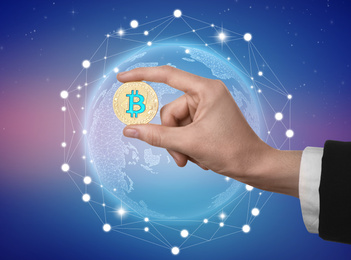 Image of Woman holding bitcoin on color background, closeup