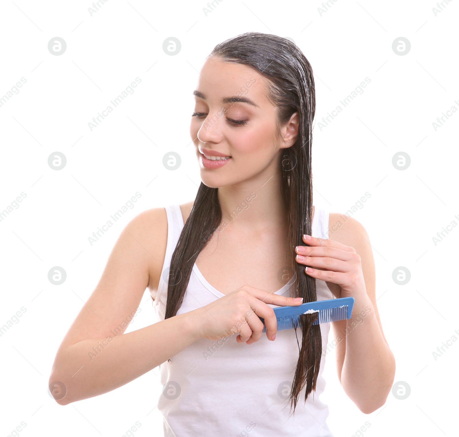 Photo of Young woman brushing hair after applying mask on white background