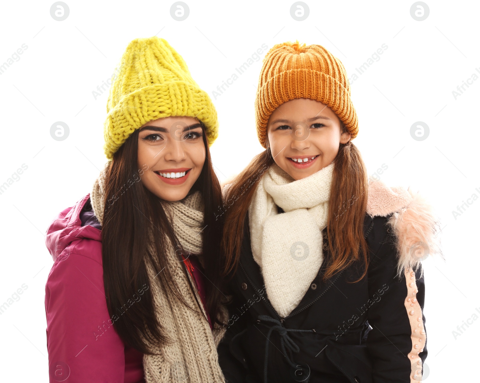 Photo of Happy mother and daughter in warm clothes on white background. Winter vacation