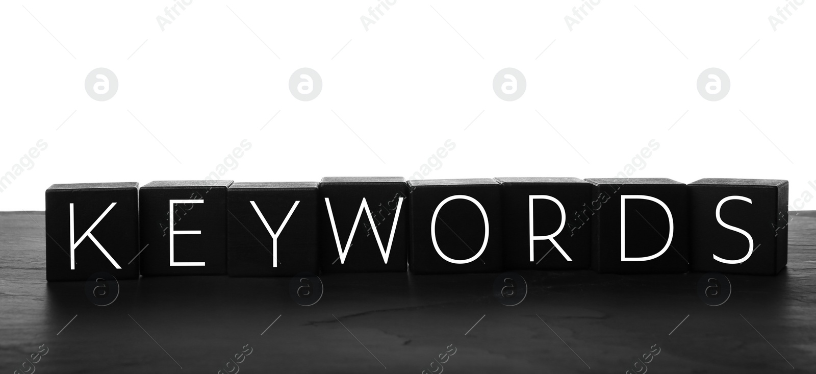 Photo of Word KEYWORDS made of black cubes on white background