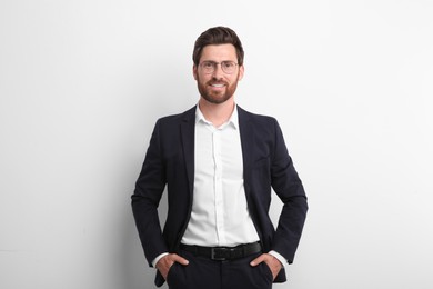 Portrait of handsome man in glasses on white background