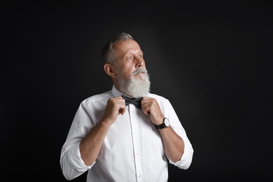 Photo of Portrait of handsome senior man on black background