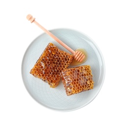 Photo of Plate with comb pieces and honey dipper isolated on white, top view