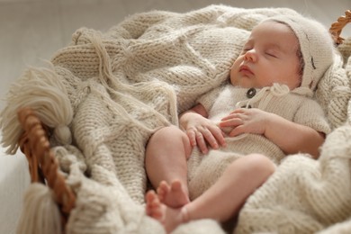 Photo of Adorable newborn baby sleeping in wicker basket