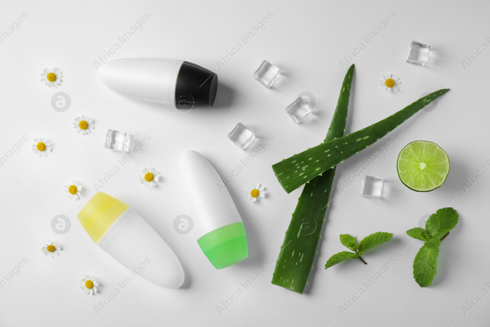 Photo of Composition with natural roll-on deodorants on white background, top view