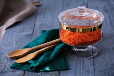 Red lentil on blue wooden table. Foodstuff for modern kitchen