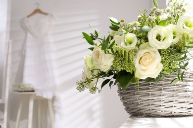 Photo of Basket with beautiful wedding flowers on window sill indoors, closeup