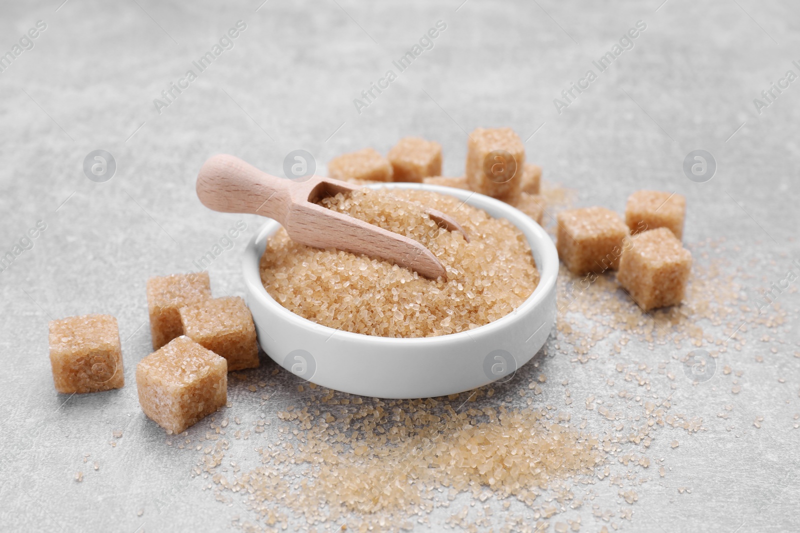 Photo of Different types of brown sugar on grey table