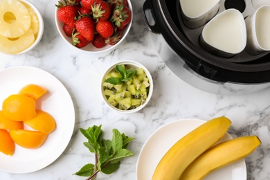 Photo of Flat lay composition with ingredients for yogurt on marble background. Multi cooker recipe