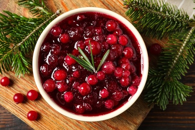 Flat lay composition with cranberry sauce on wooden board