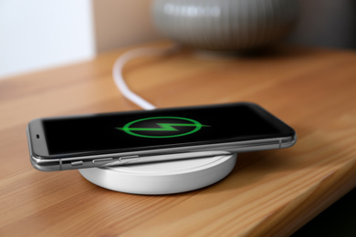 Smartphone charging on wireless pad in room