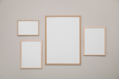 Empty frames on grey wall. Mockup for design