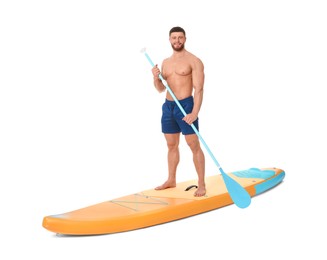 Happy man with paddle on orange SUP board against white background