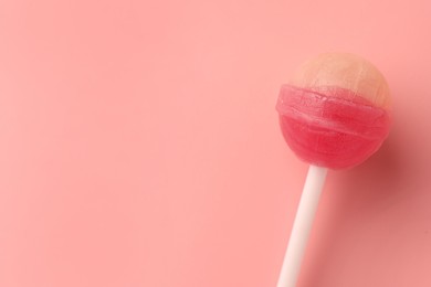 Photo of Tasty lollipop on pink background, top view. Space for text