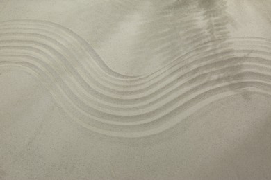 Beautiful lines and shadows of leaves on sand. Zen garden