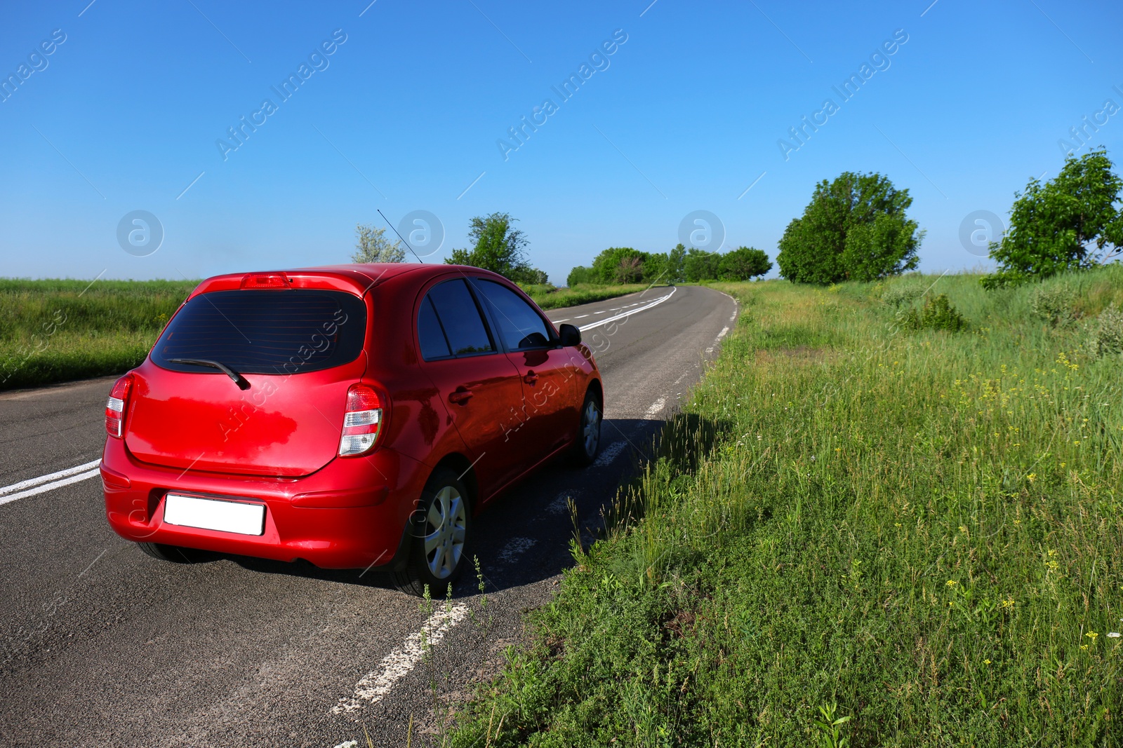 Photo of Modern color family car on highway. Space for text