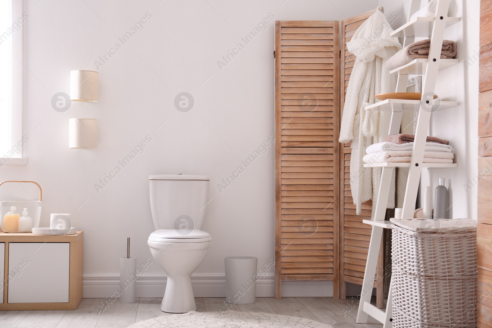 Photo of Ceramic toilet bowl in stylish bathroom. Idea for interior design