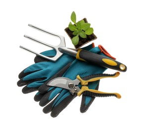 Different gardening tools on white background, top view