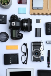 Flat lay composition with equipment for professional photographer on white background