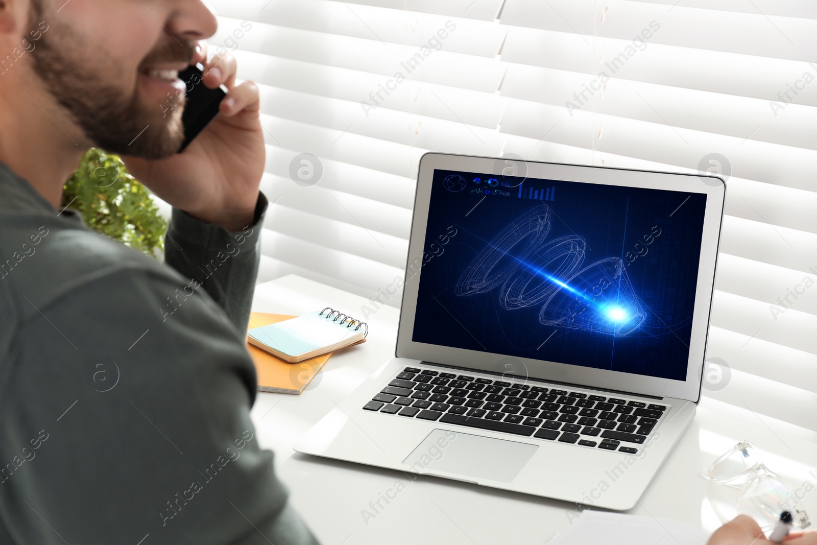 Image of Male engineer working with 3d model of modern equipment on laptop in office, closeup