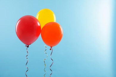 Photo of Bright balloons on color background, space for text. Celebration time