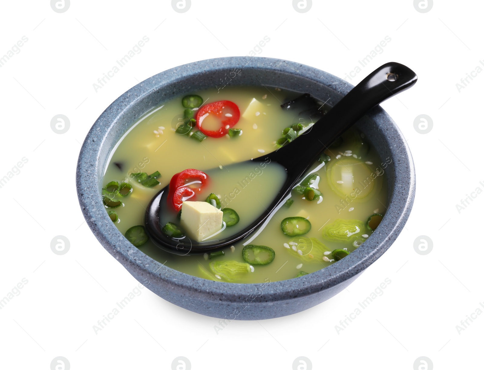 Photo of Bowl of delicious miso soup with tofu and spoon isolated on white