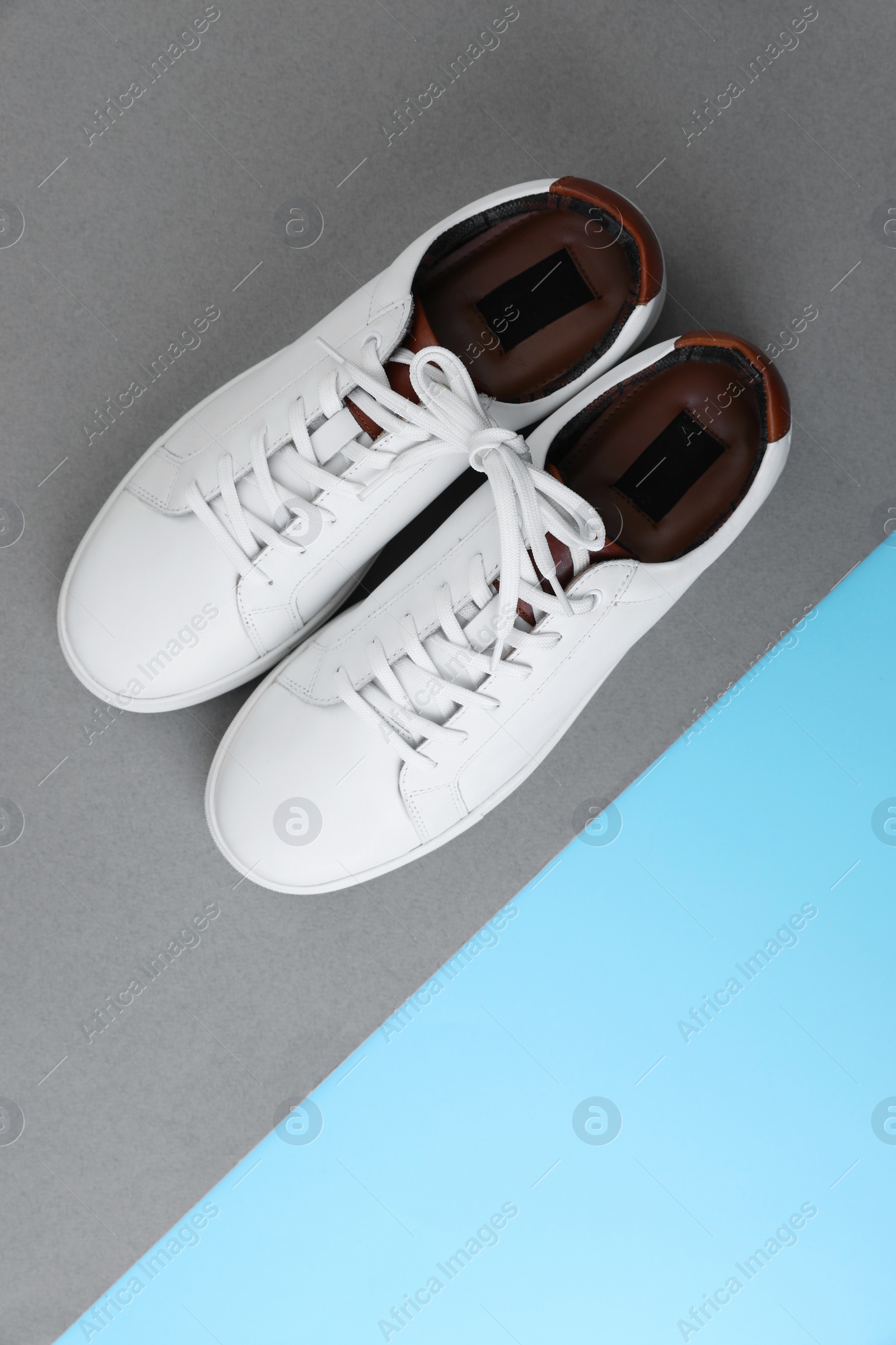 Photo of Pair of stylish sports shoes on color background, flat lay