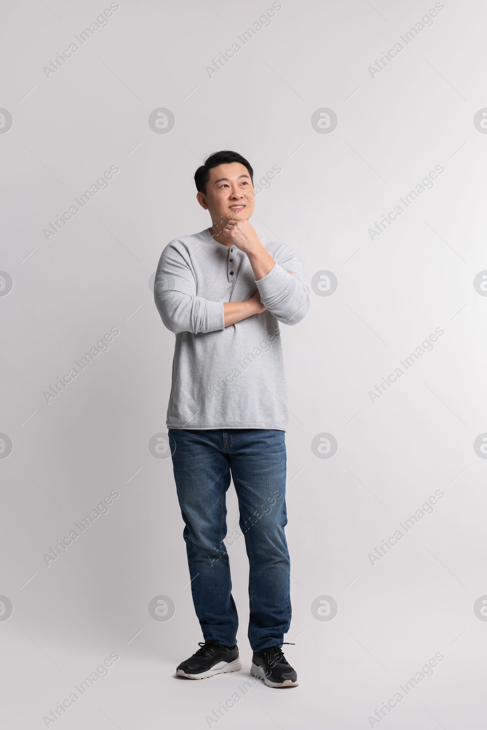 Photo of Full length portrait of happy man on light background