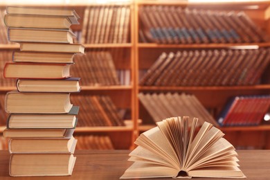 Different books on wooden table in library