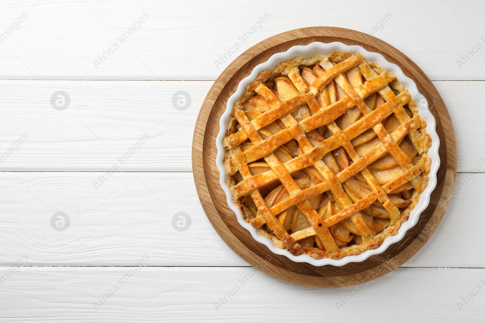 Photo of Tasty homemade quince pie on white wooden table, top view. Space for text