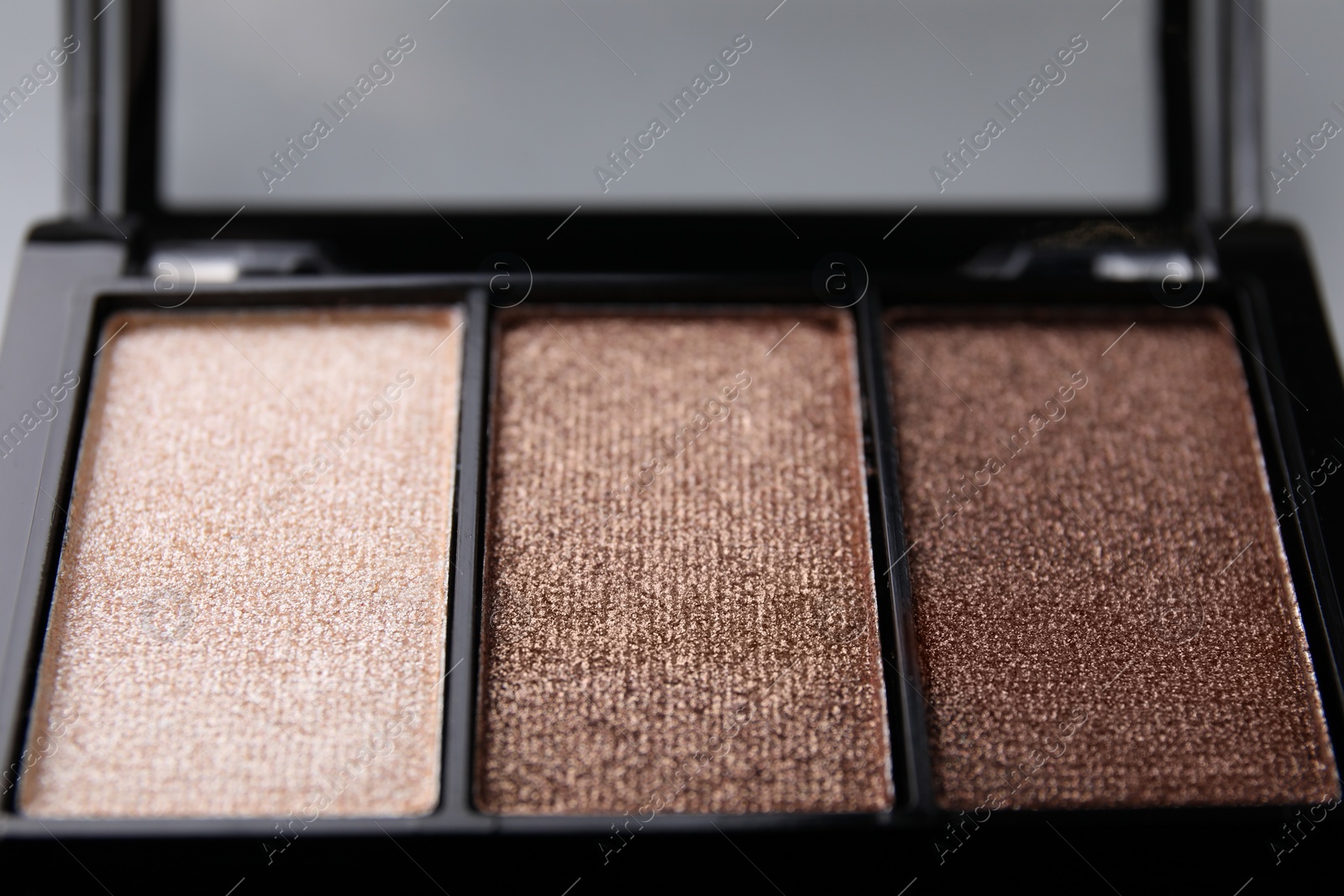 Photo of Beautiful eyeshadow palette on light gray background, closeup. Professional cosmetic product