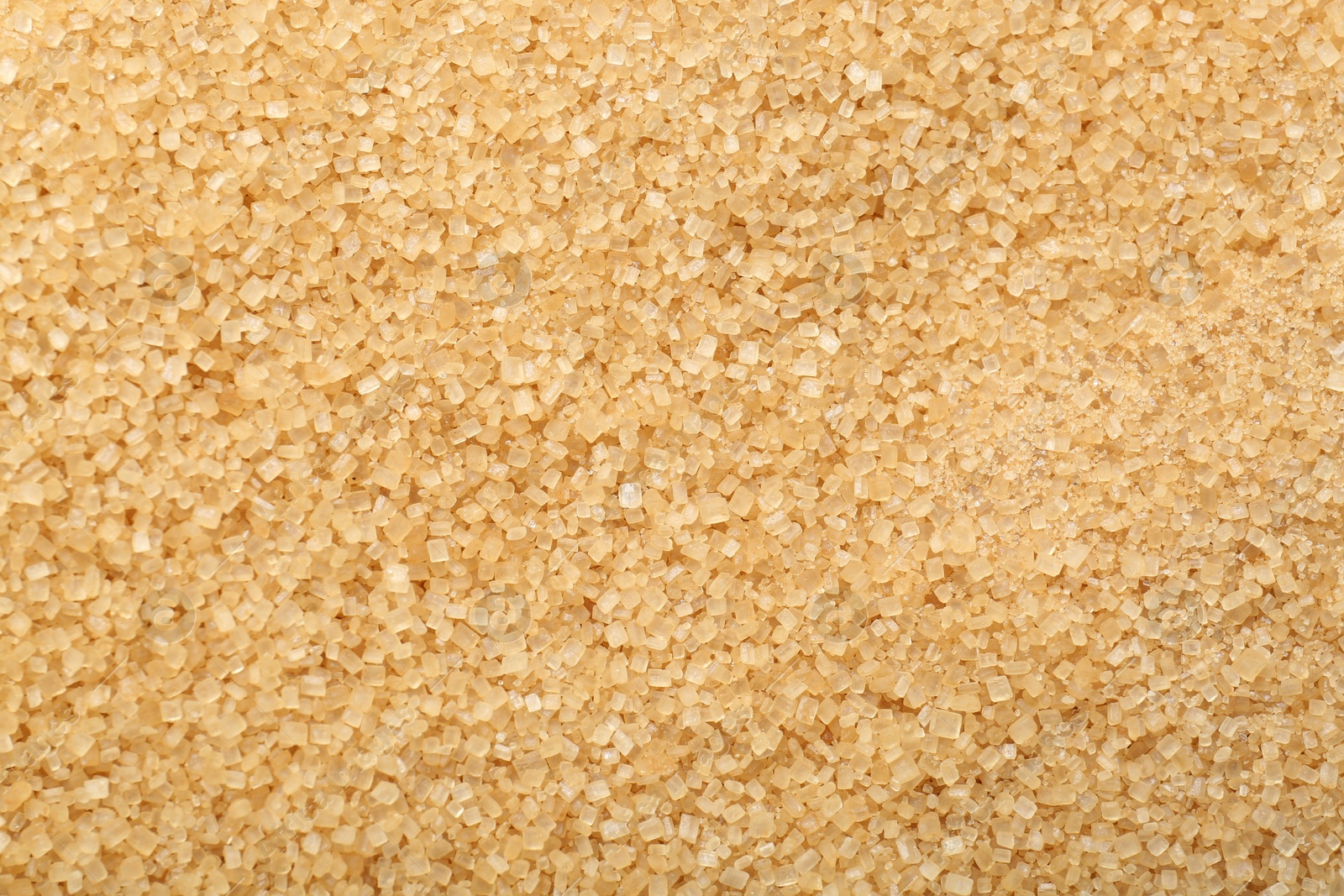 Photo of Granulated brown sugar as background, top view