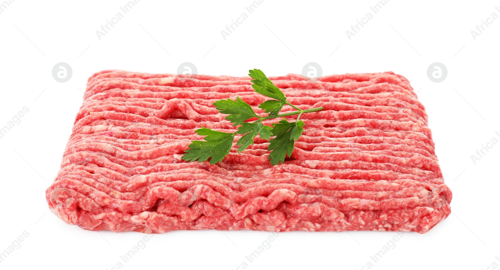 Photo of Raw ground meat and parsley isolated on white