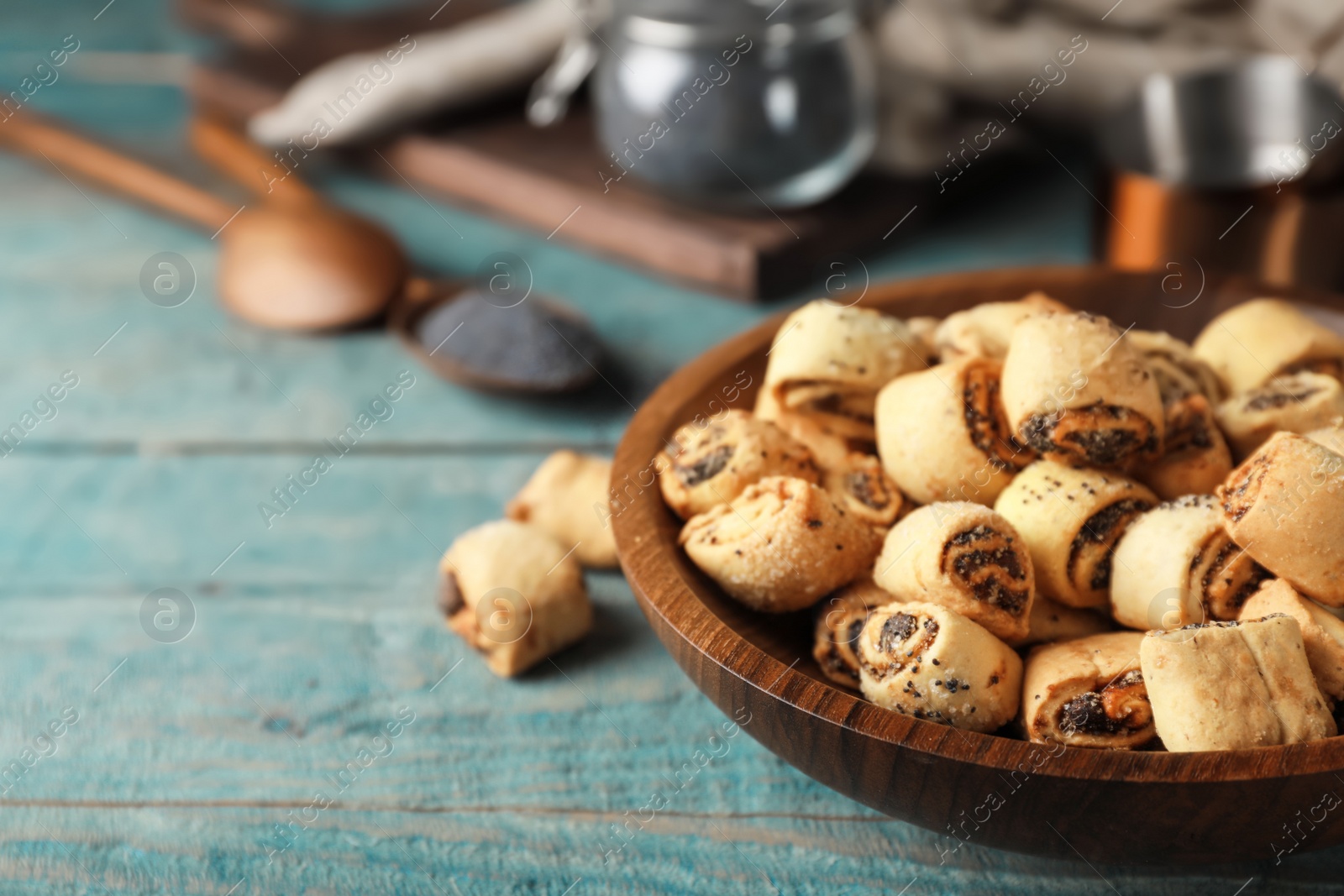 Photo of Tasty sweet cookies with poppy seeds on wooden table. Space for text