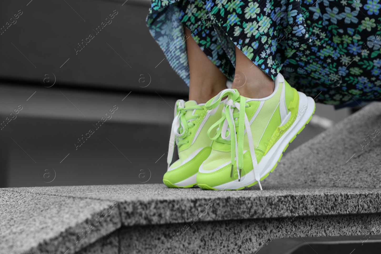 Photo of Woman wearing stylish sneakers outdoors, closeup. Space for text