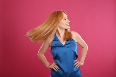 Photo of Beautiful young woman with blonde hair on pink background