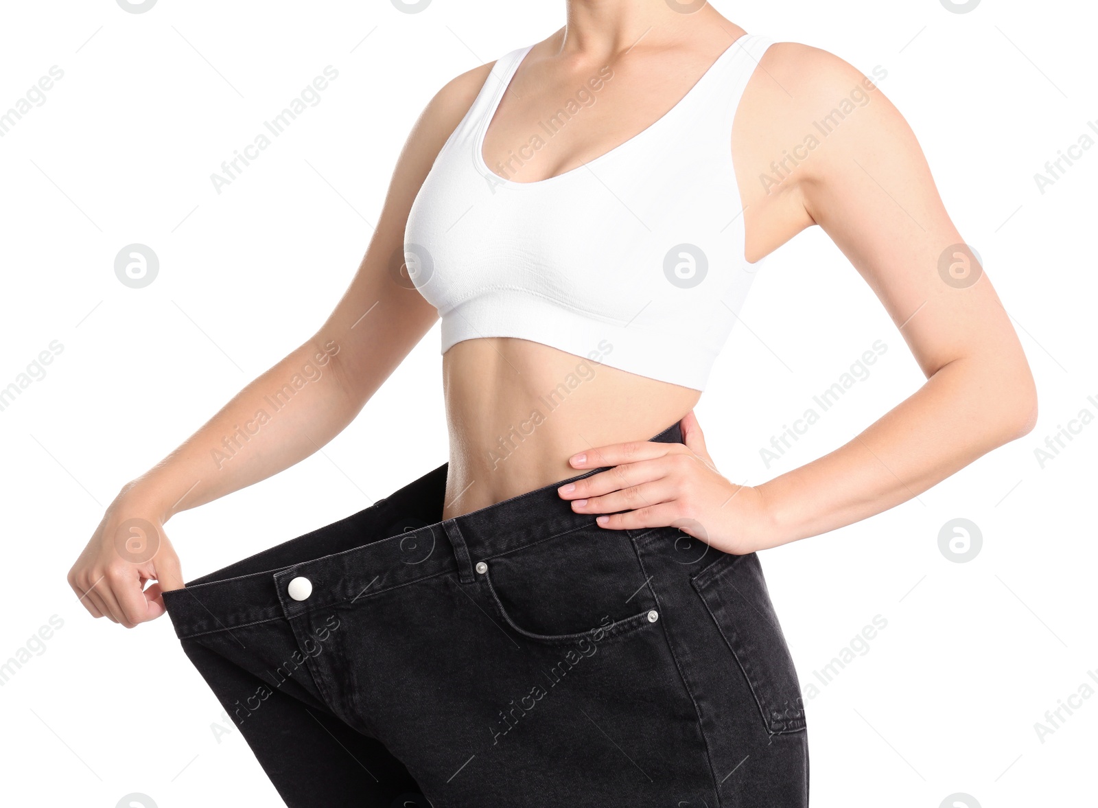 Photo of Young slim woman wearing oversized jeans on white background, closeup