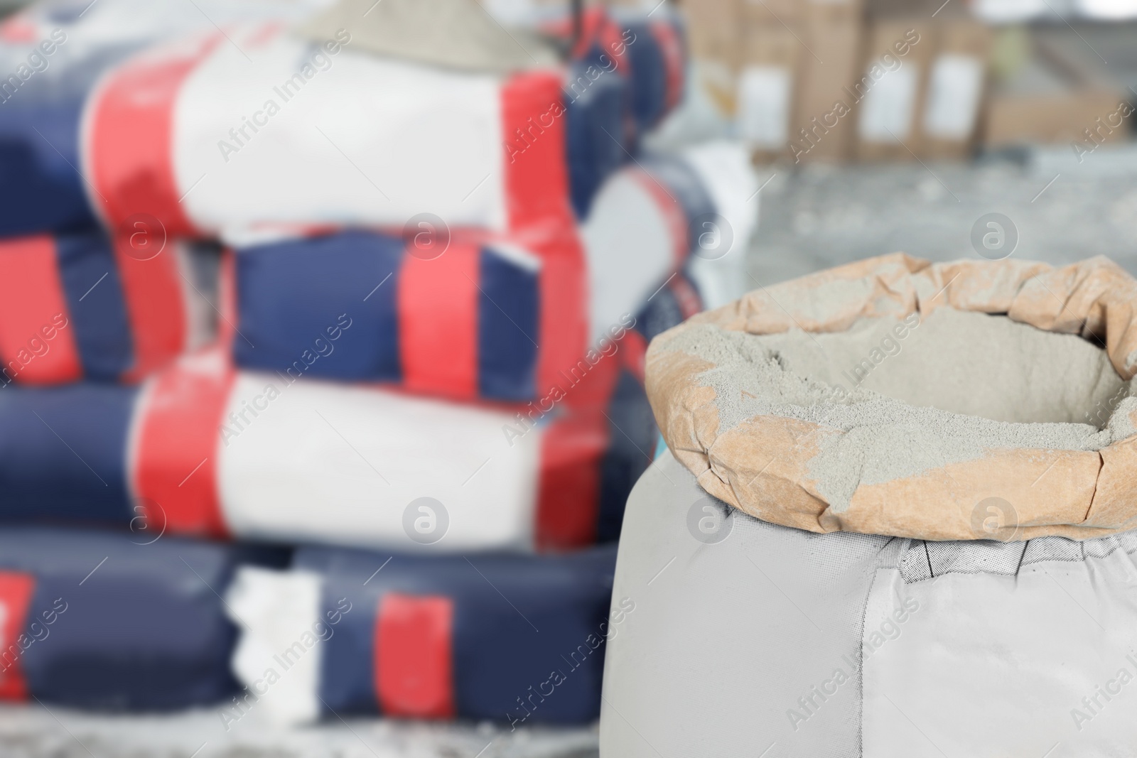 Photo of Cement powder in bag indoors, closeup. Space for text