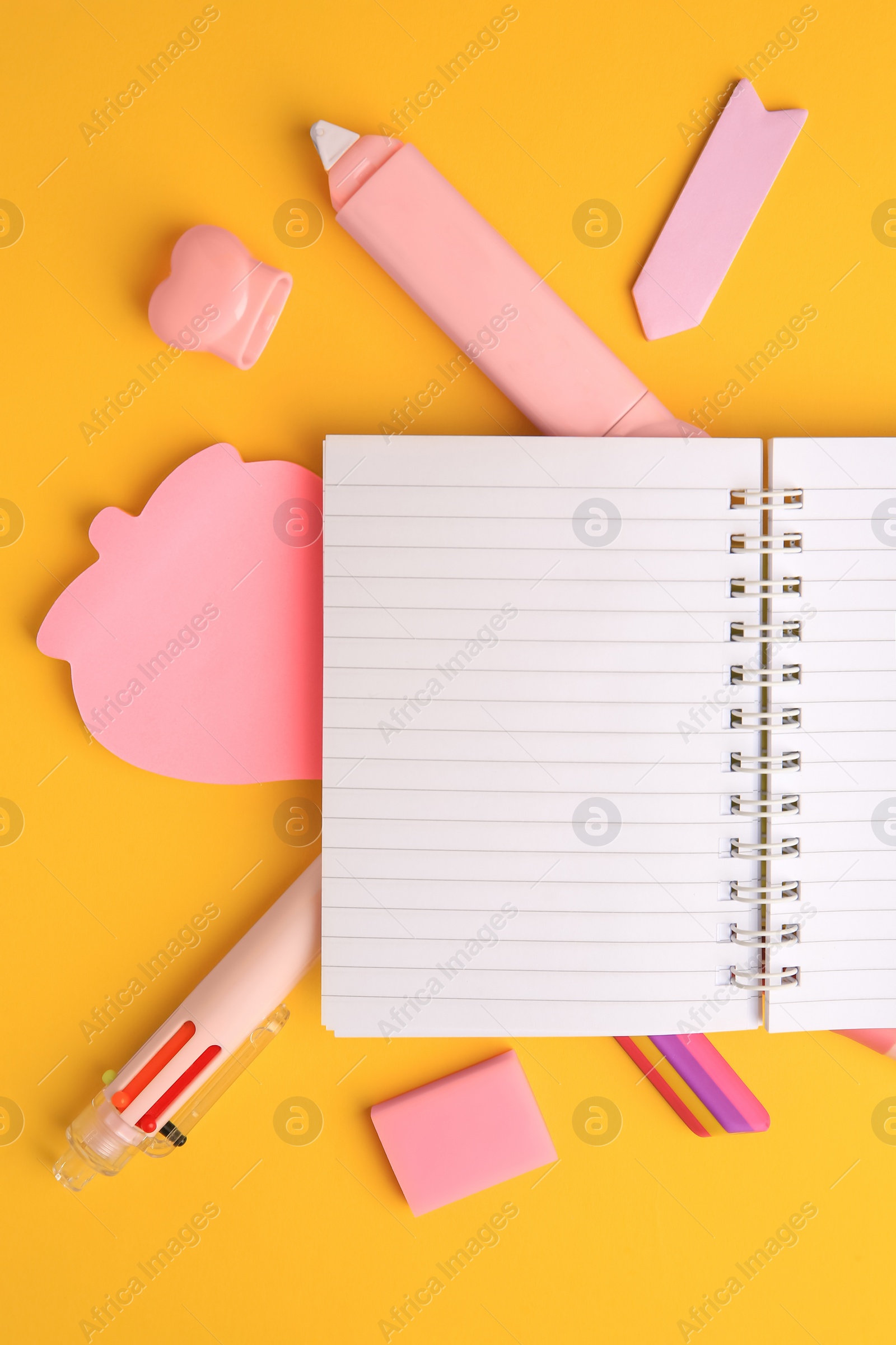 Photo of Flat lay composition with open notebook and different school stationery on yellow background, space for text. Back to school