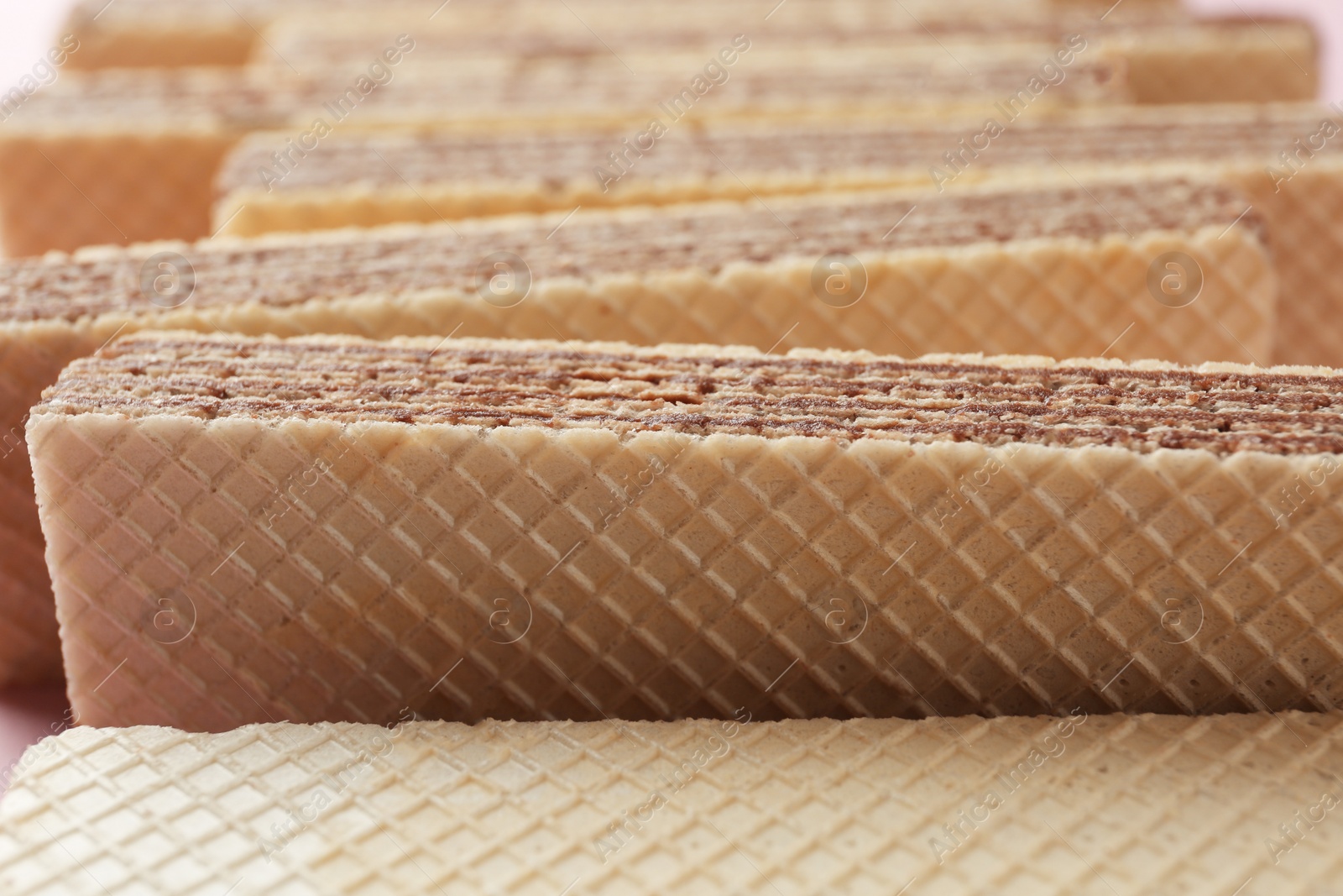 Photo of Tasty chocolate wafer sticks, closeup. Sweet food