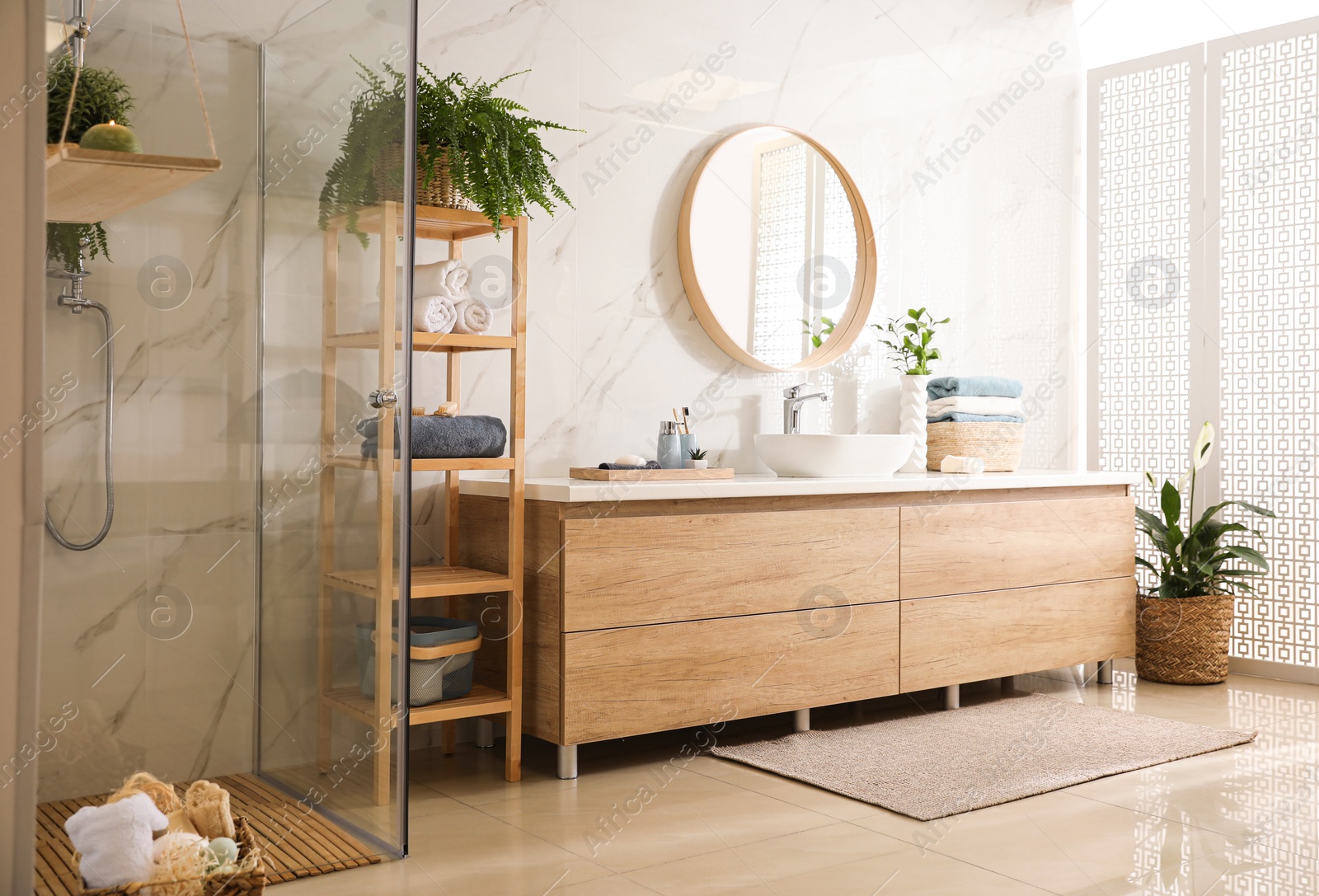Photo of Stylish bathroom interior with countertop, mirror and shower stall. Design idea