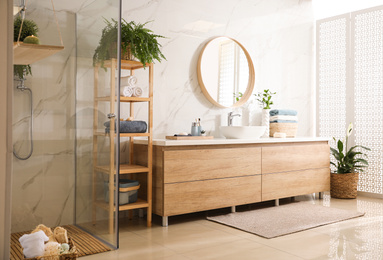 Stylish bathroom interior with countertop, mirror and shower stall. Design idea