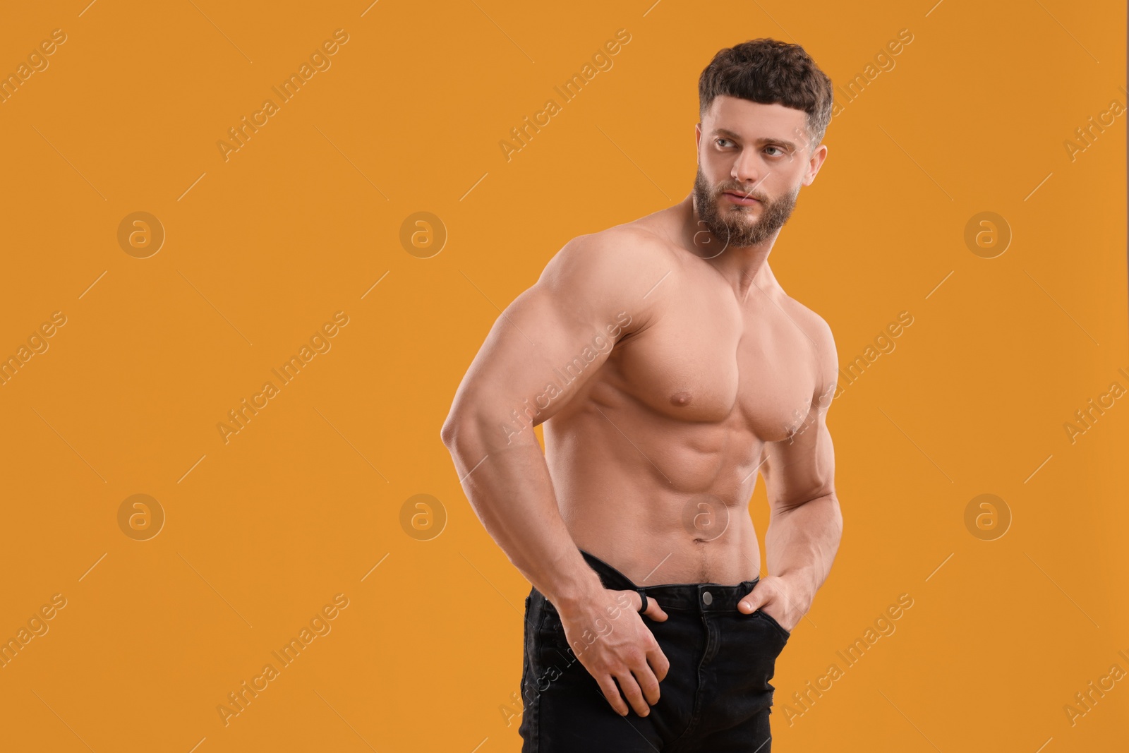 Photo of Handsome muscular man on orange background, space for text. Sexy body