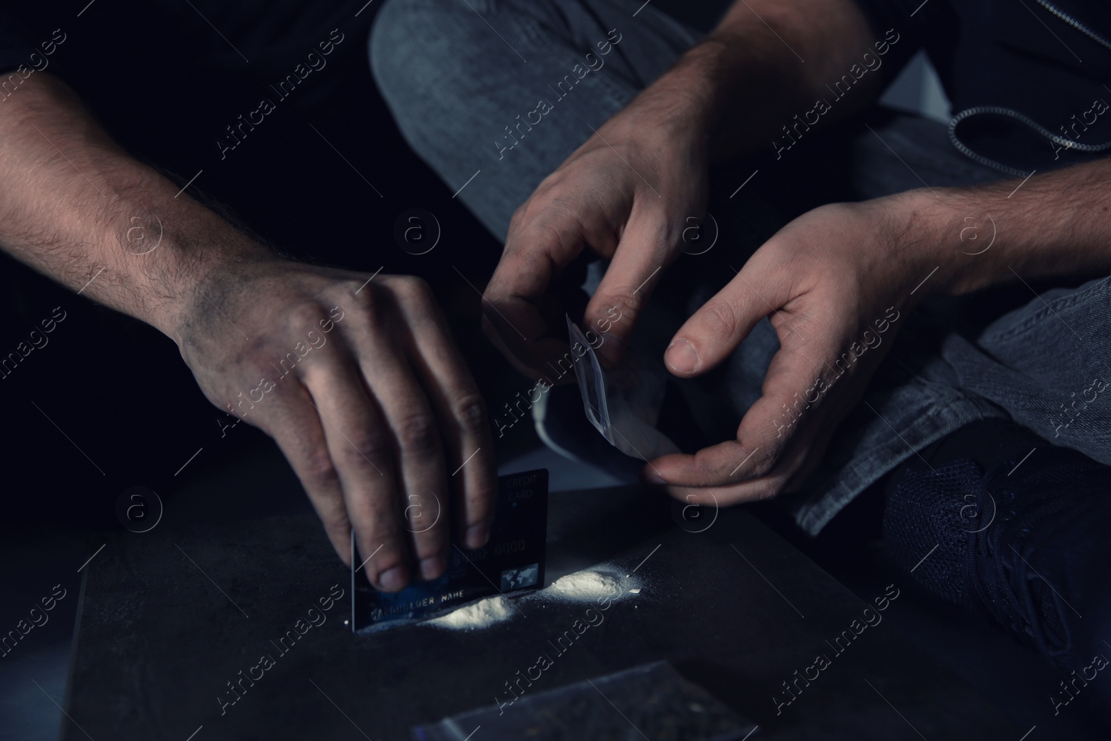 Photo of Young addicted men taking drugs, closeup of hands