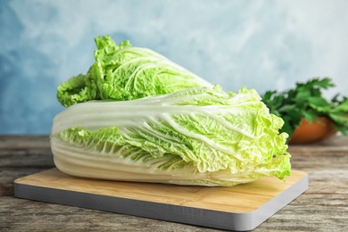 Photo of Fresh ripe cabbages on wooden board